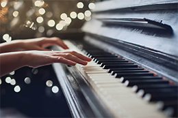 Close up of hands playing the piano.