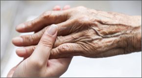 Young person holding an elder's hand