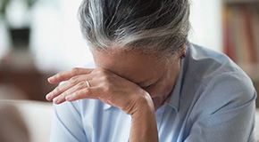 Woman with head in hands