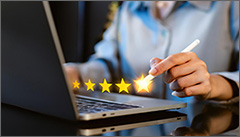 User on a laptop rating a product with stars