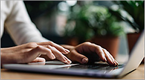 Closeup shot hands using laptop