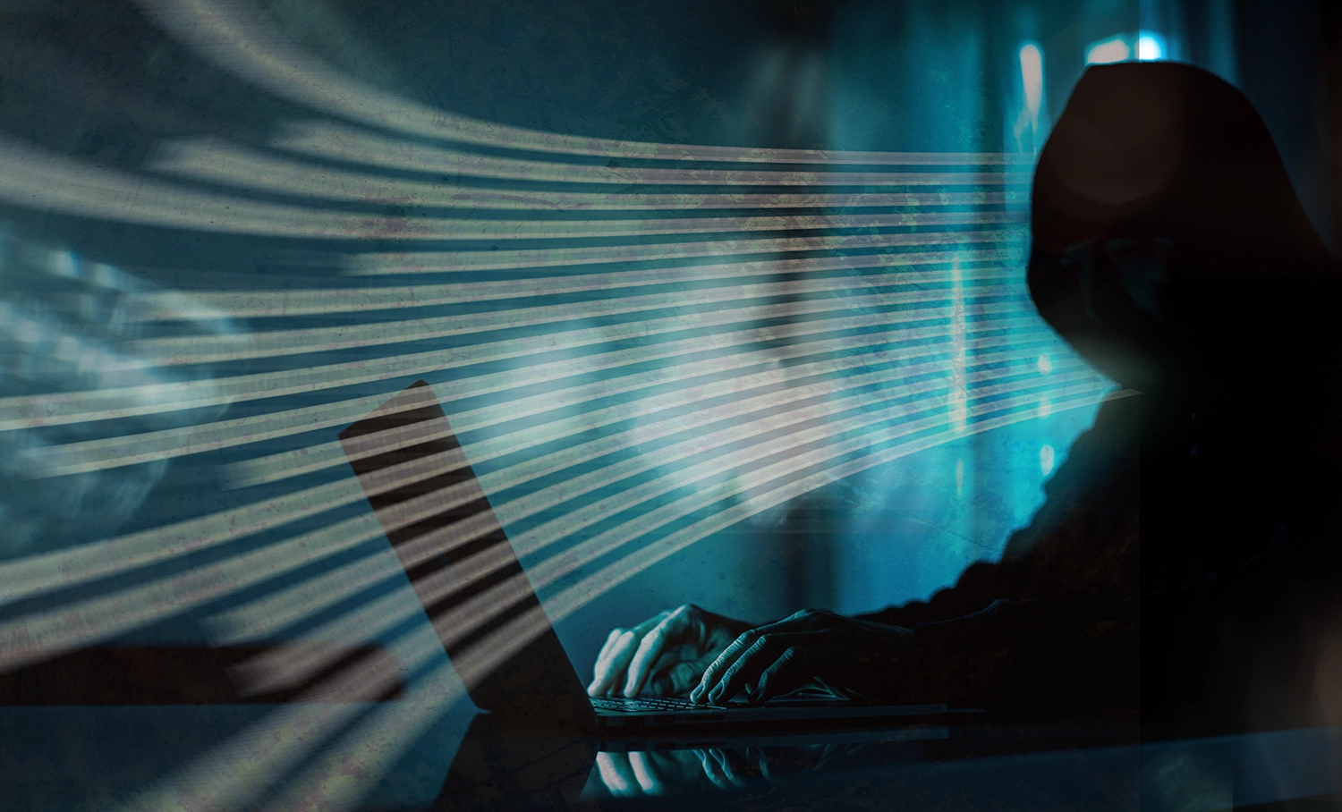 Cyber criminal working on a keyboard